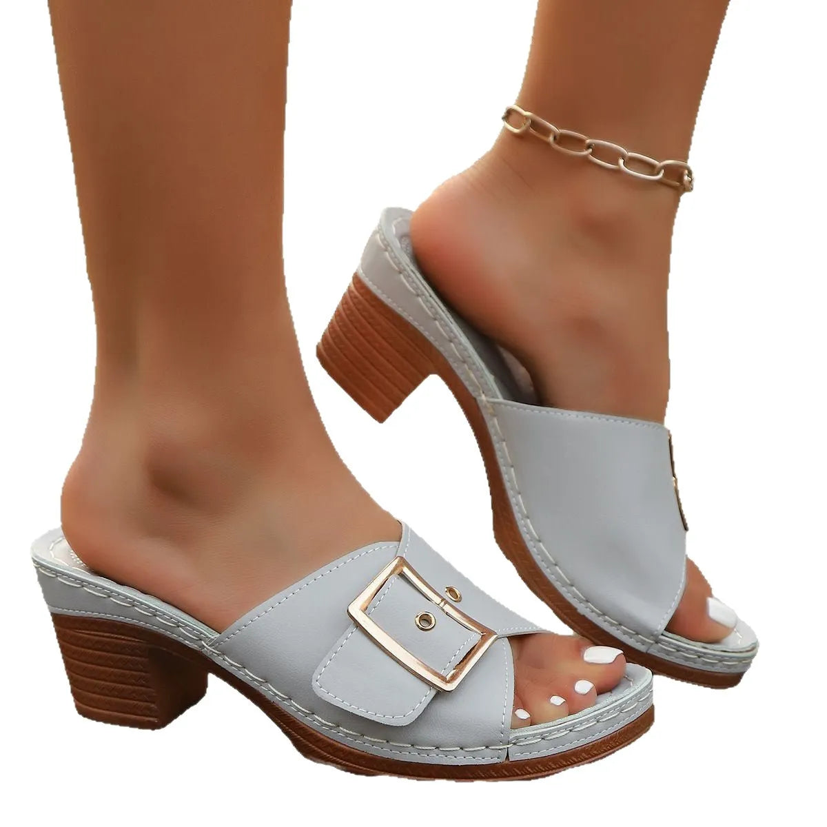 A pair of women's black retro-style slippers with a chunky heel and a prominent silver metal buckle across the instep.