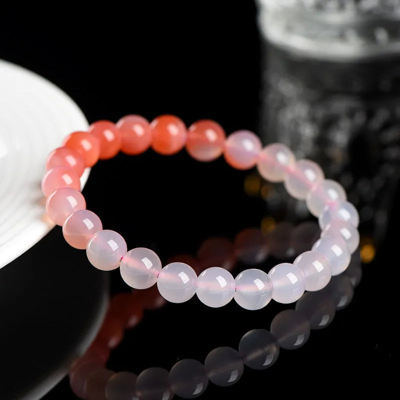 Natural gradient Yanyuan agate bracelet with geometric beads in salt source colour on a wrist.