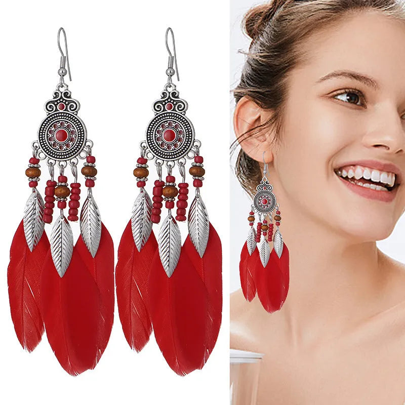 A pair of bohemian-style round drop earrings with a feather leaf pattern, shown in one of thirteen available colours.