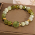 Xiuyan jade green women's bracelet with an original bangle design on a plain background.