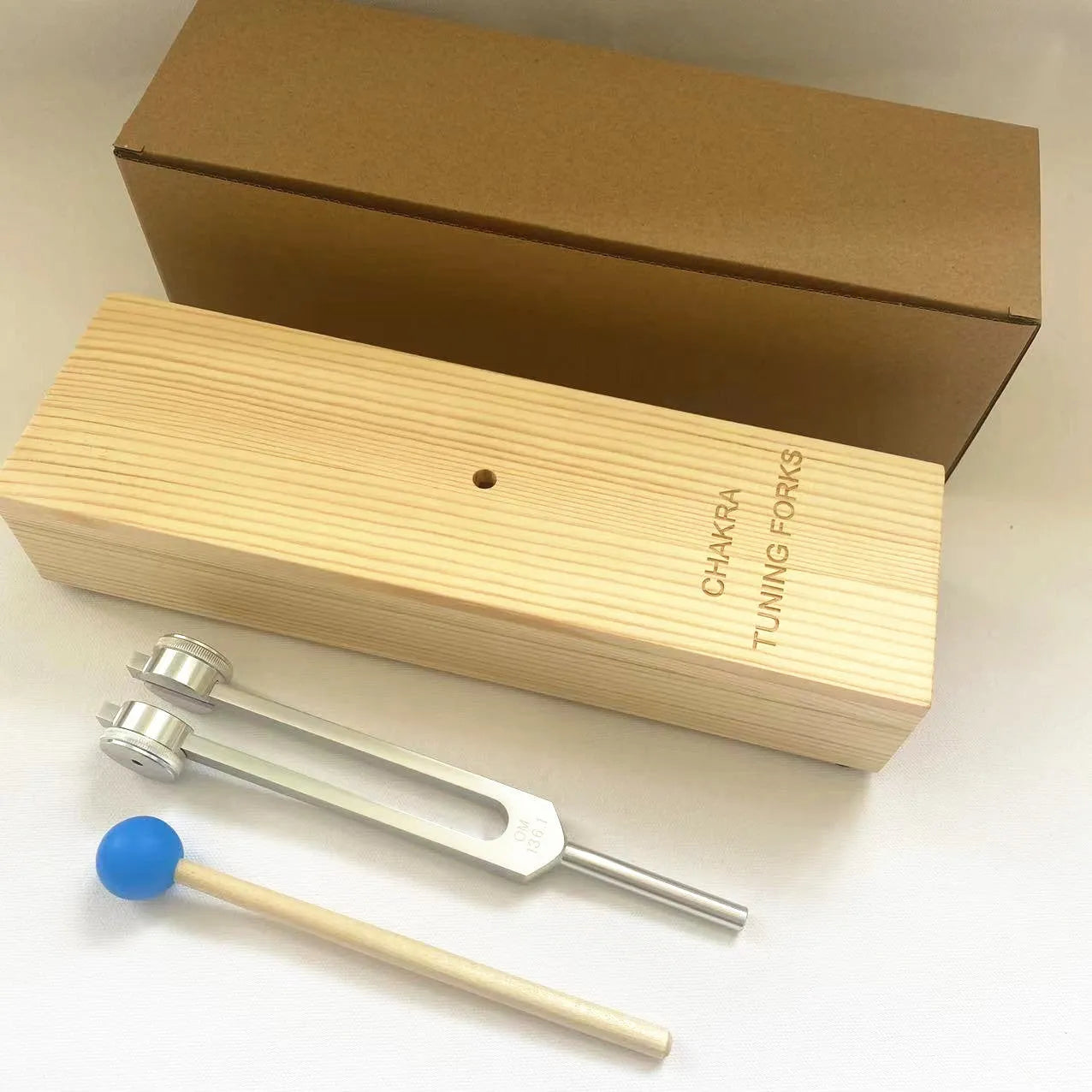 Aluminium alloy 432Hz tuning fork and portable speaker set in kraft paper box.
