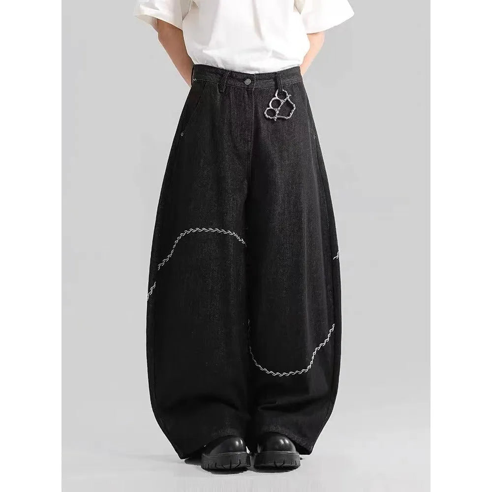 Black straight-leg denim trousers for teenagers on a hanger, showing mid-waist and zip fly detail.
