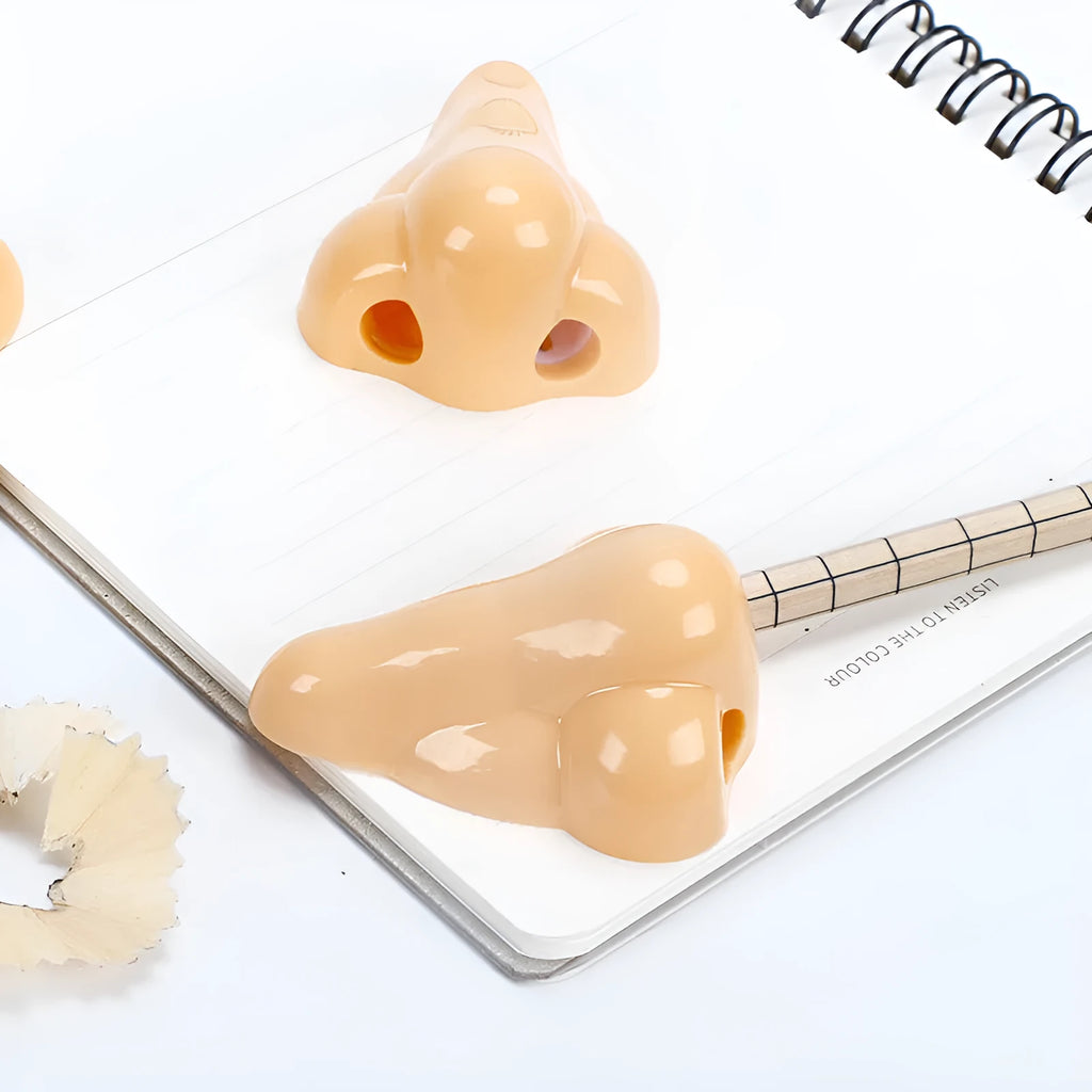 Flesh colour plastic pencil sharpener with geometry shape measuring 58x45x30 mm