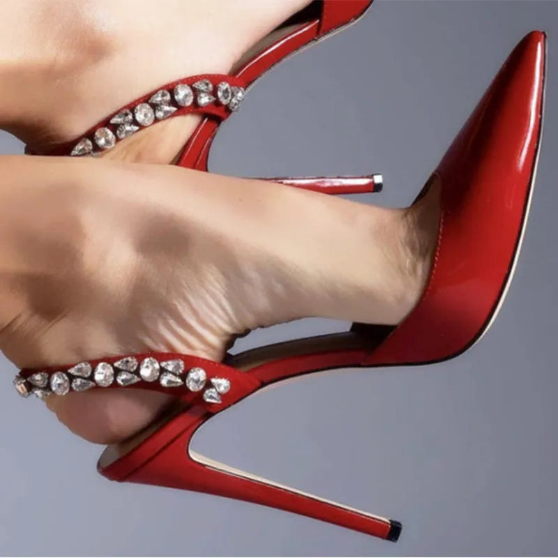 Women's pointed toe high heel sandals with rhinestone detail on patent leather upper.