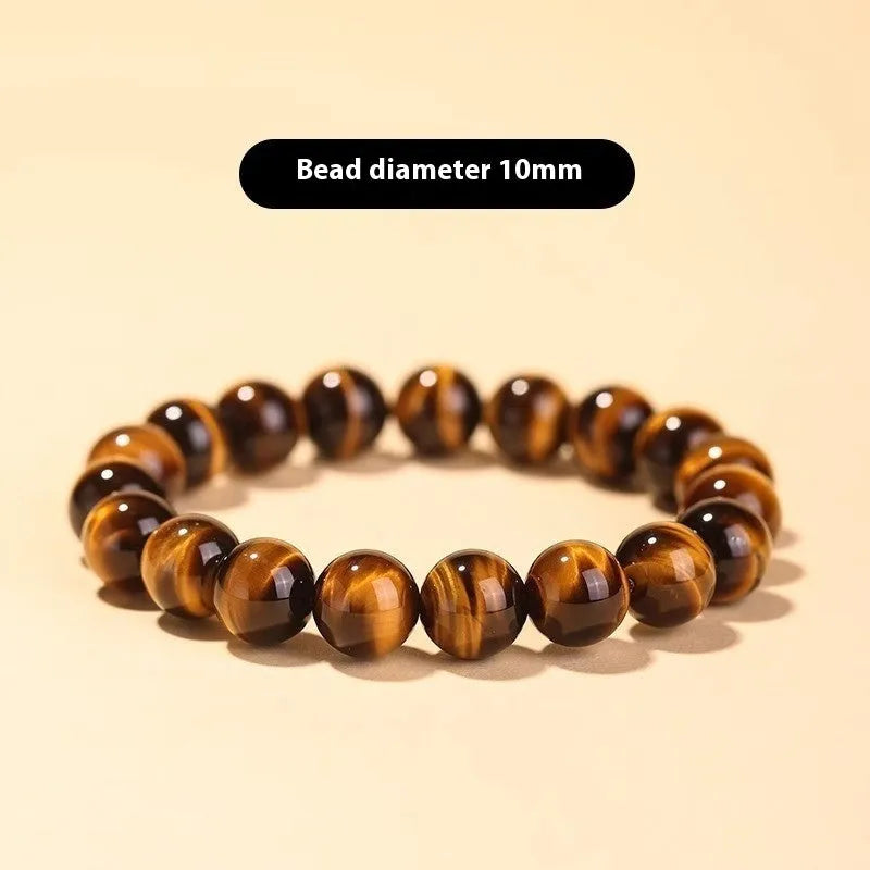 Close-up of a single-circle beaded Buddha rosary bracelet with tigereye dzi patterns on brown beads.