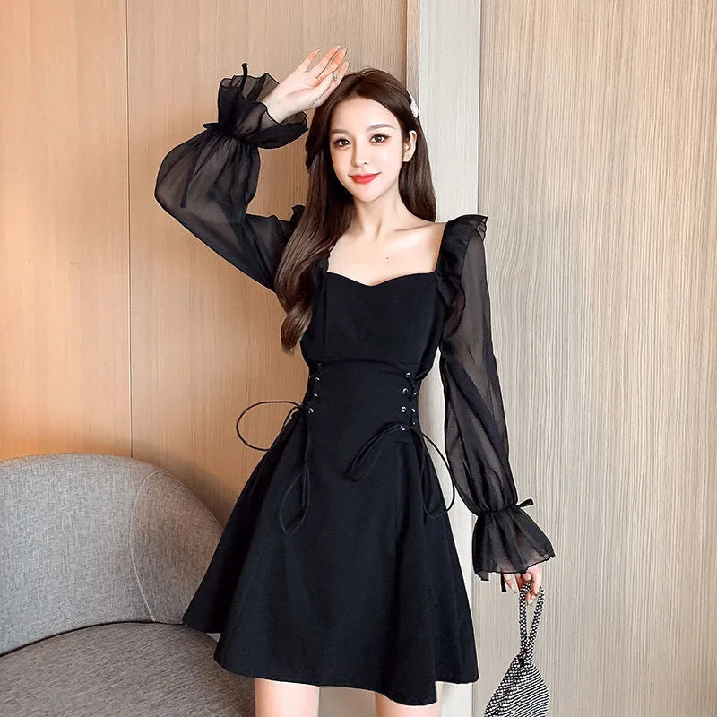 White women's chiffon dress with patchwork detail, long sleeves, and a waist-slimming long skirt.