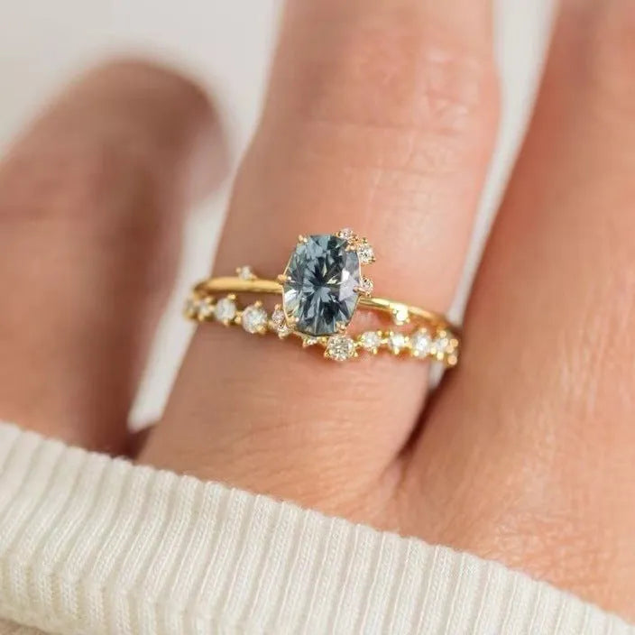Gold plated floral pattern ring with green zircon stone inlay on woman's finger