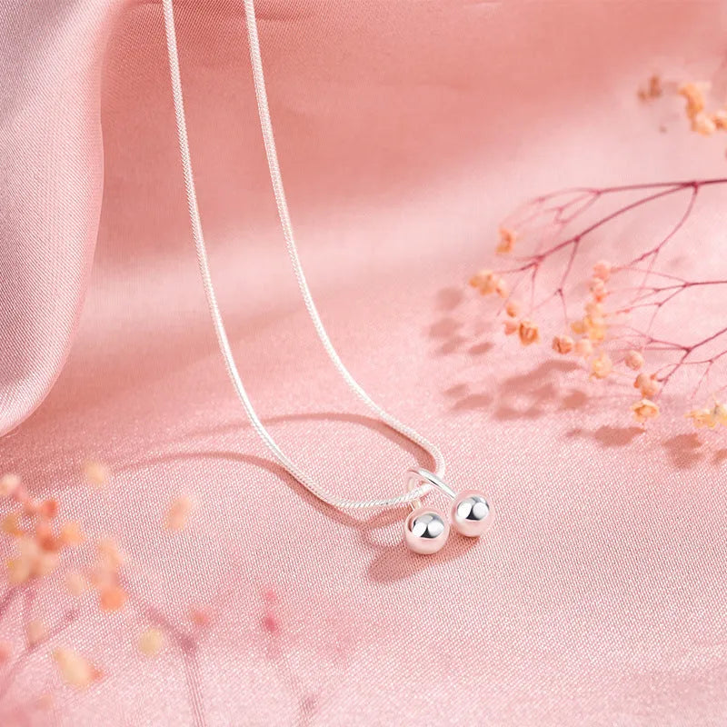 Sterling silver cherry pendant necklace on a snake bone chain, adjustable from 21cm to 50cm.