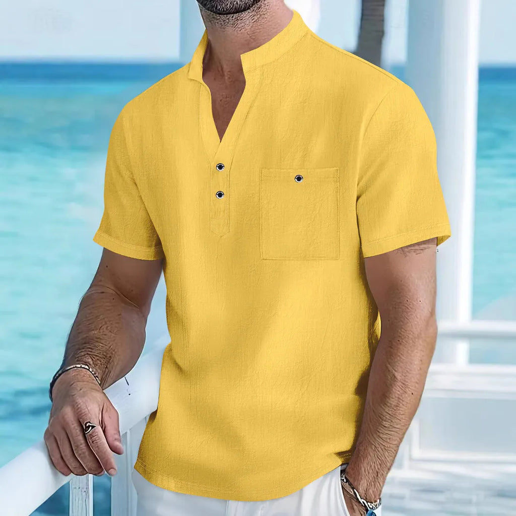 Man wearing a light-coloured linen stand collar short sleeve t-shirt in a relaxed fit.