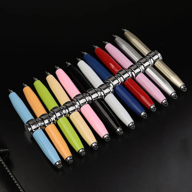 Metal ballpoint pen with a built-in fingertip gyro spinner and LED light, shown in multiple ink colour options.