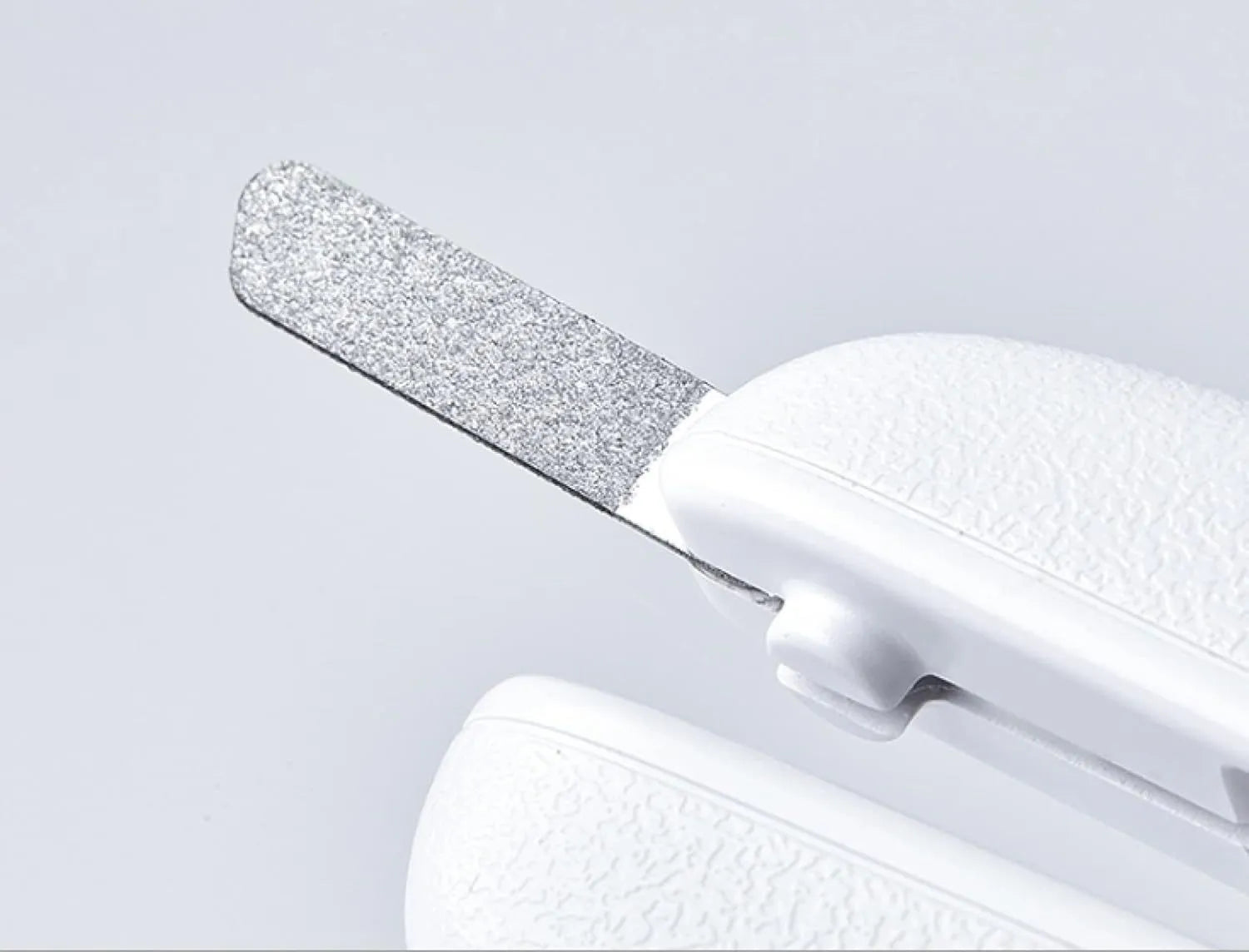 White LED pet nail clippers with open anti-splash guard and nail file on a solid colour background