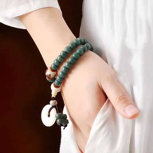White jade and bodhi seed beaded bracelet with a double ring safety buckle clasp.