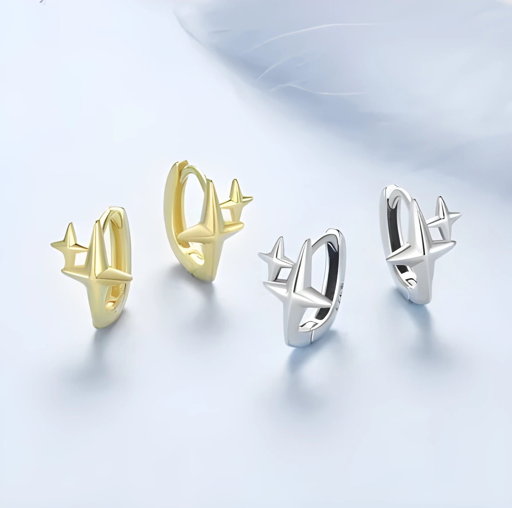 Minimalist sterling silver star ear clips with oxidised finish and ear clip design