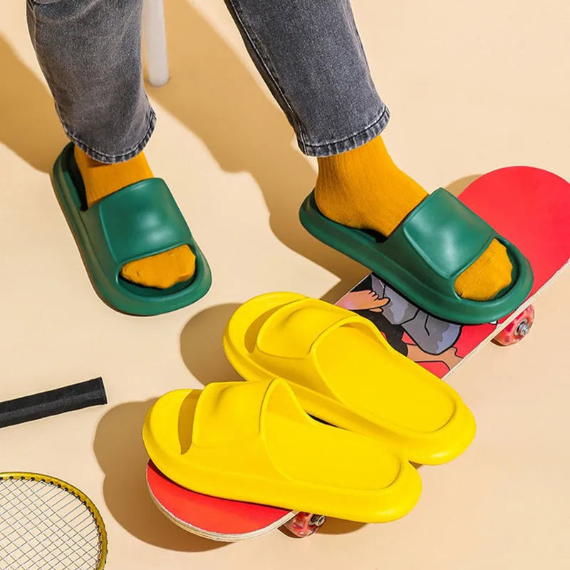 Thick-soled EVA flip-flop slippers in multiple colours on a bathroom floor, showing non-slip sole texture.