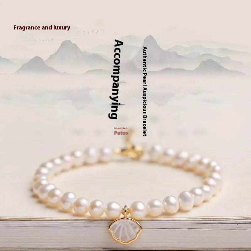 Women's freshwater pearl bracelet with fan-shaped design and alloy details.