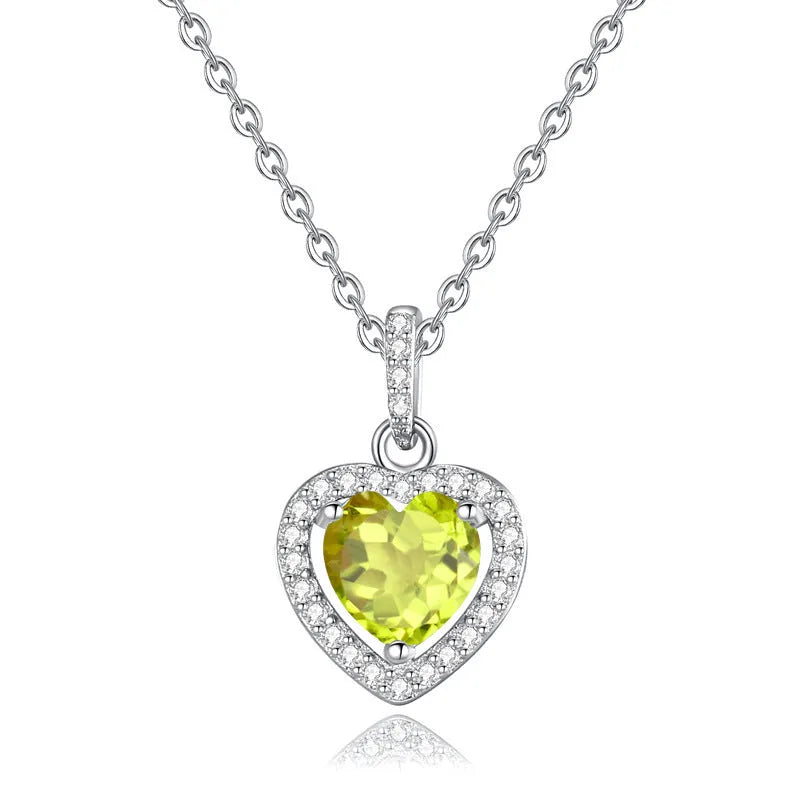 Heart-shaped sterling silver pendant necklace with a natural gemstone on an adjustable chain.