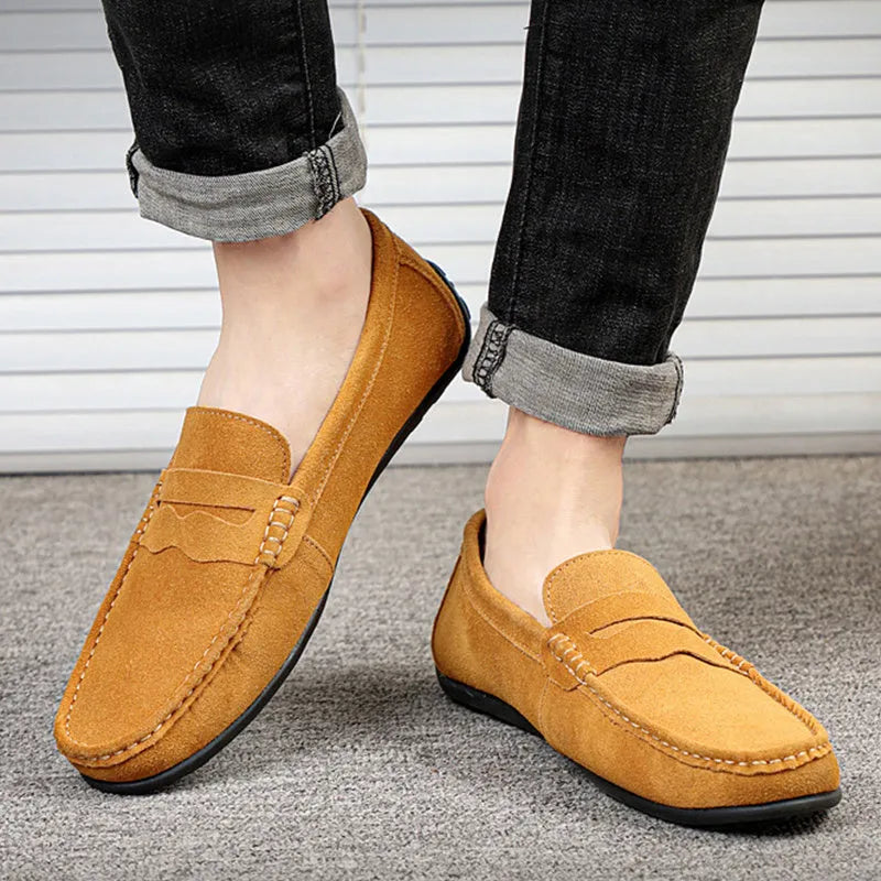 Men's suede slip-on loafers in a solid colour with a round toe and flat rubber sole.