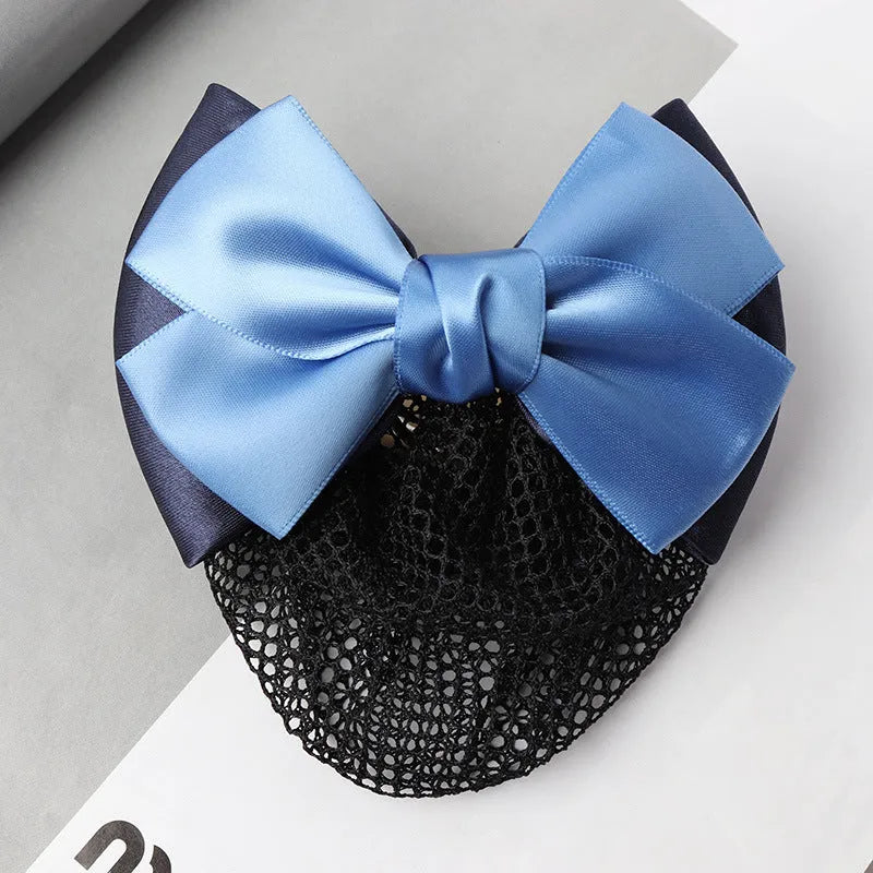Professional flower bow headdress hair clip ornament on a work plate, shown in a selection of net and mesh colour variations.