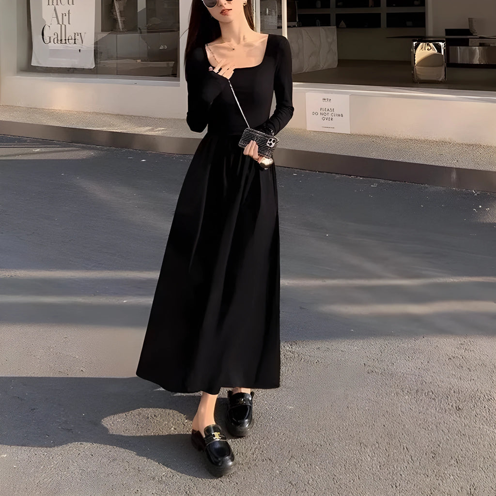 Women's black knitted dress with square collar and elastic waistband showing A-line long skirt design