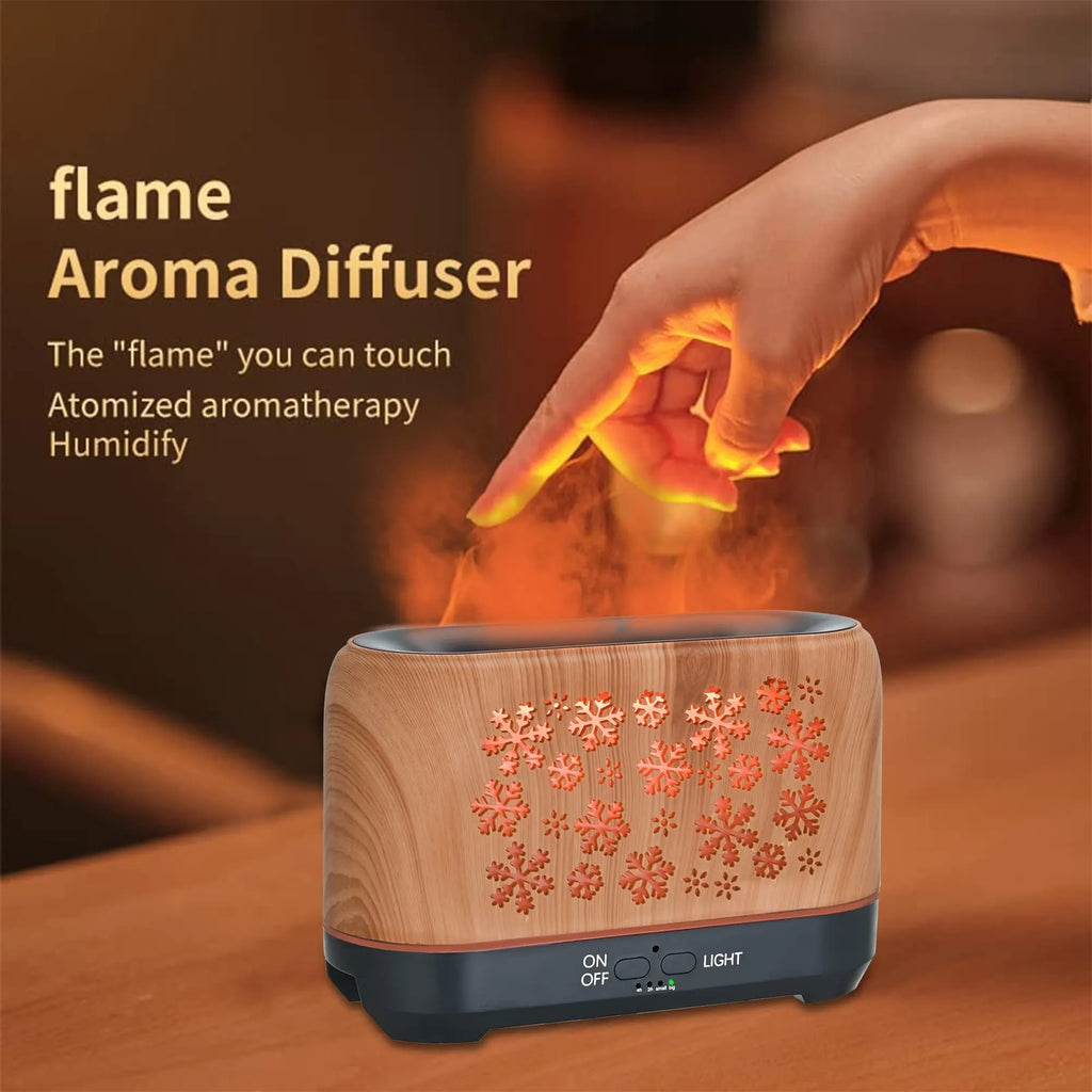 Christmas snowflake pattern humidifier with colourful flame effects and remote control on wooden desk