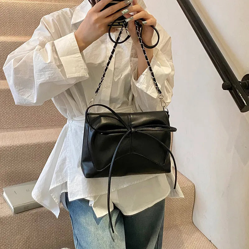 Women's underarm crossbody bag in horizontal square shape with sewing line details and phone pocket