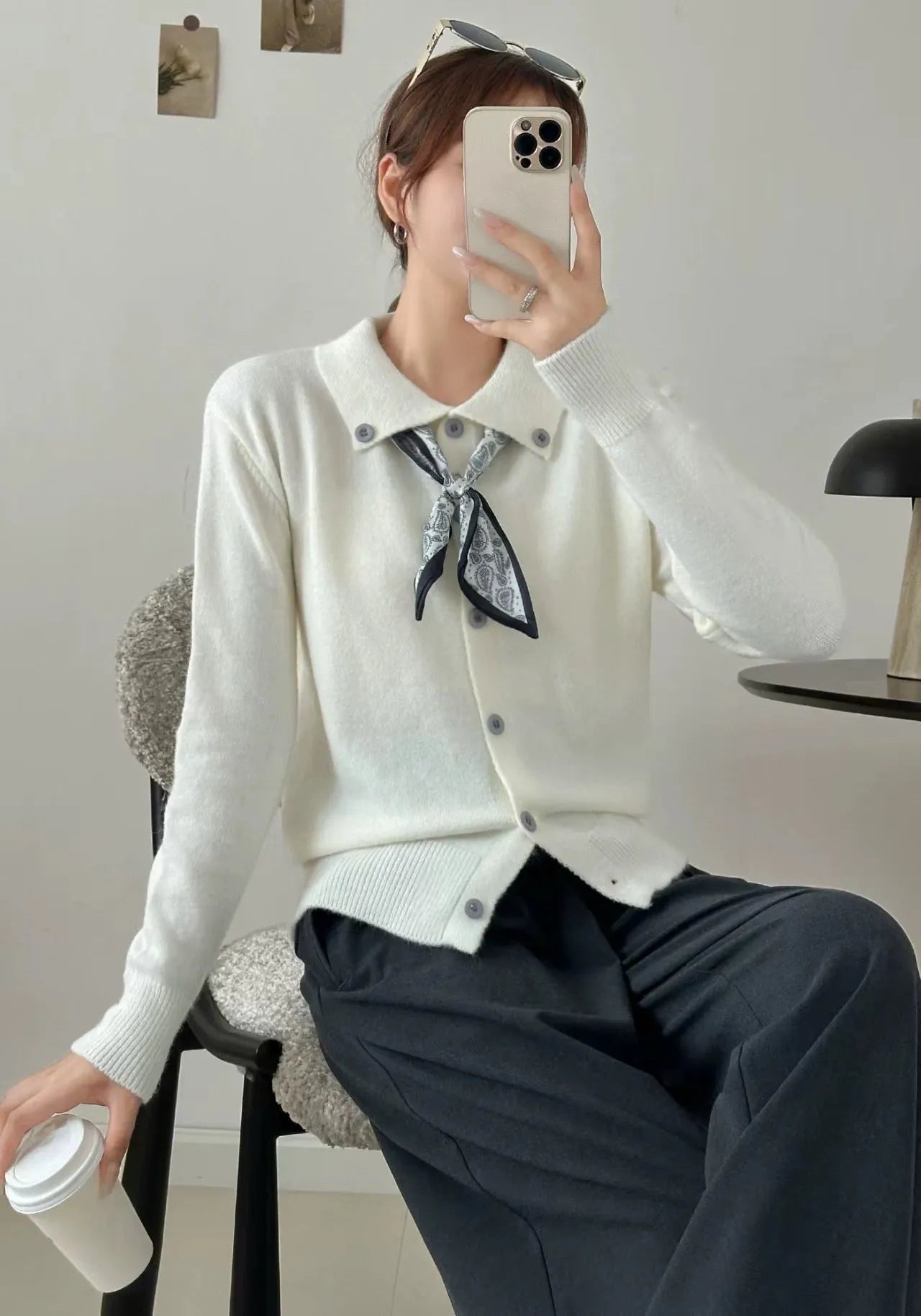 Beige cardigan sweater with attached lapel scarf and long sleeves on a model.
