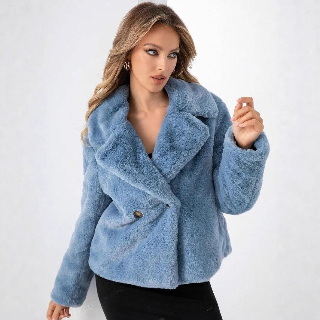 Loose short women's coat in rose red faux fur with regular sleeves on a hanger.