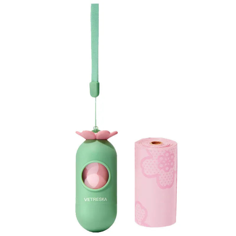 Refillable plastic dog poo bag dispenser capsule with a roll of scented biodegradable bags in strawberry design.