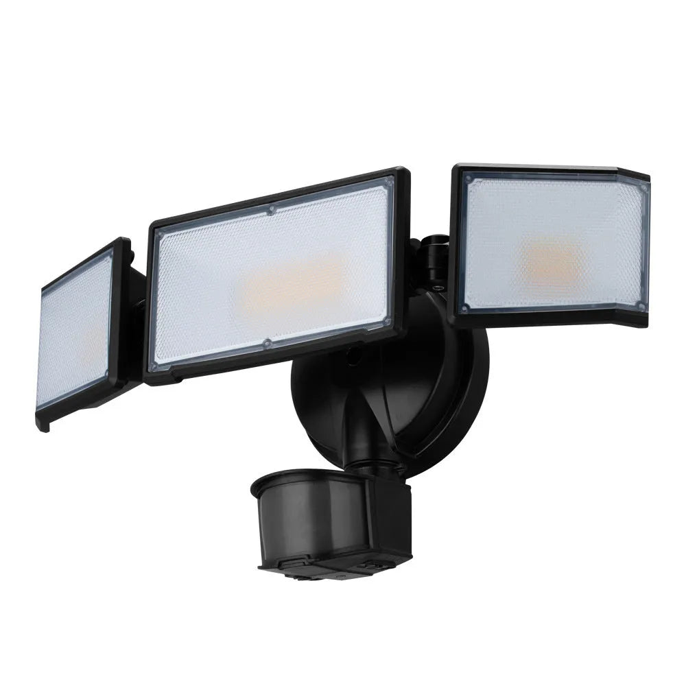 White LED security flood light with motion sensor mounted on exterior wall