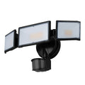 White LED security flood light with motion sensor mounted on exterior wall