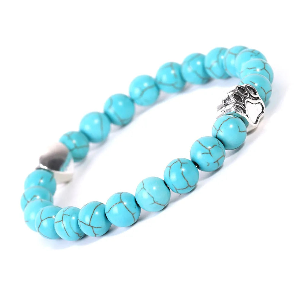 A round beaded stone bracelet in a Tiger Eye or Indian Agate style on a wrist.