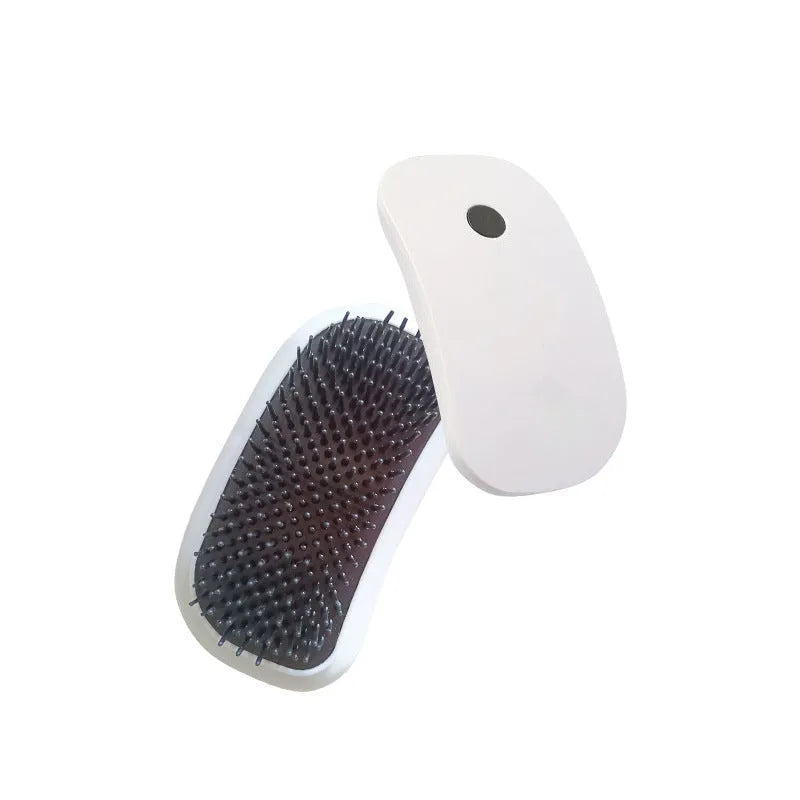 Pink handheld electric vibration pet grooming brush with soft TPE teeth on a white background.
