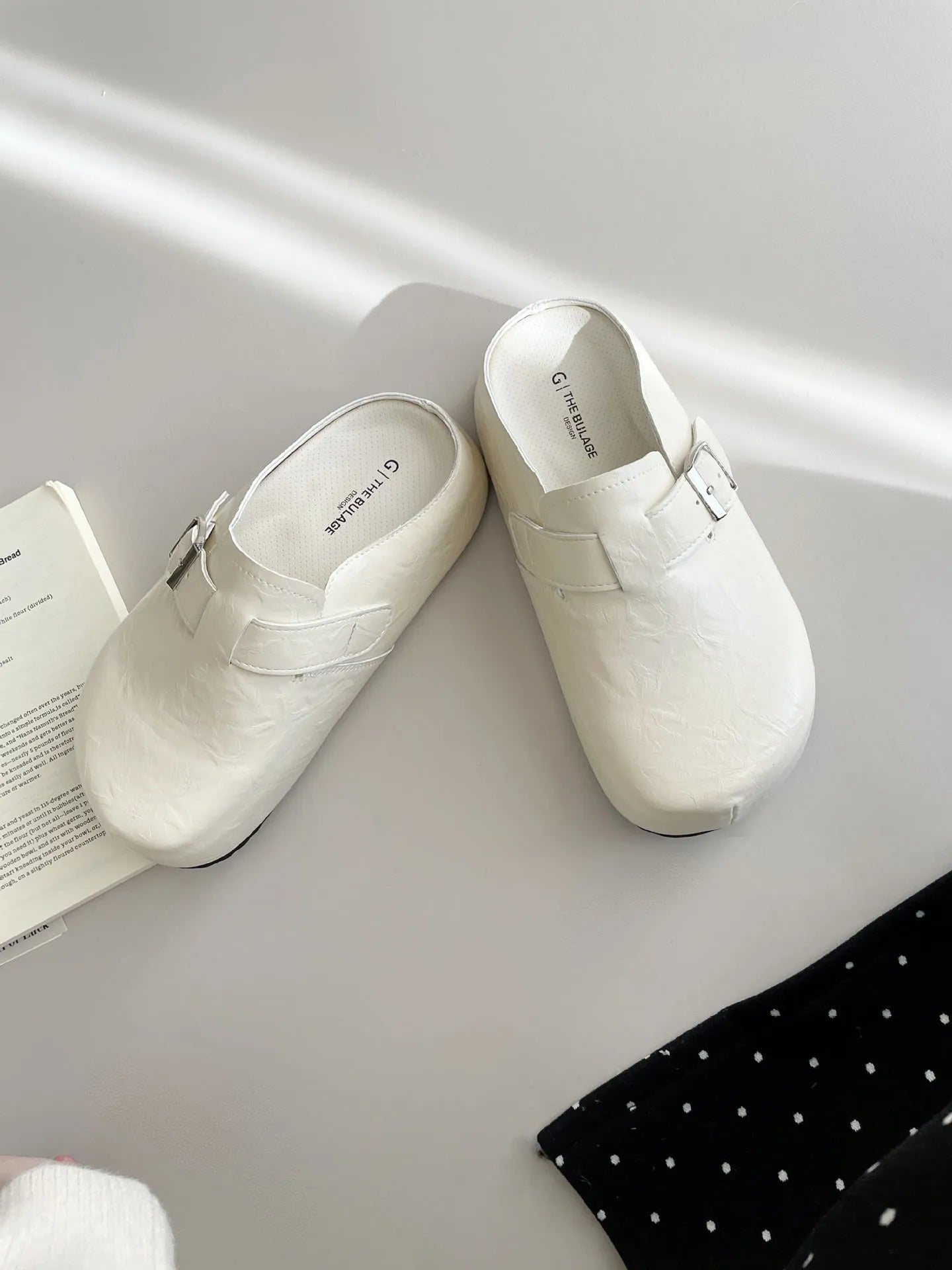 Flat buckle casual sneakers in yellow, black, silver, and creamy-white colours with rounded toe shape