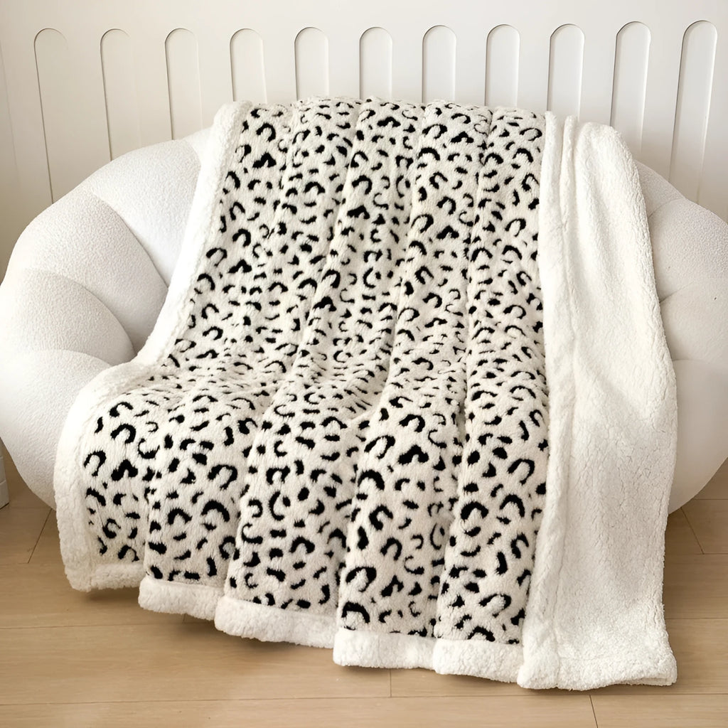 Double-layer cationic leopard jacquard taffeta blanket showing leopard print pattern in camel colour.