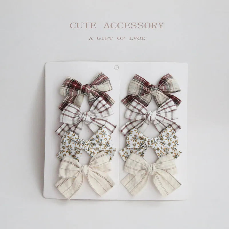 Children's fabric bow hairclips set showing dovetail design in multiple colour options