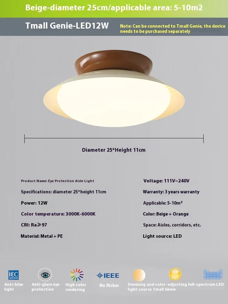 Modern minimalist flying saucer design ceiling lamp in cream yellow on a white ceiling.