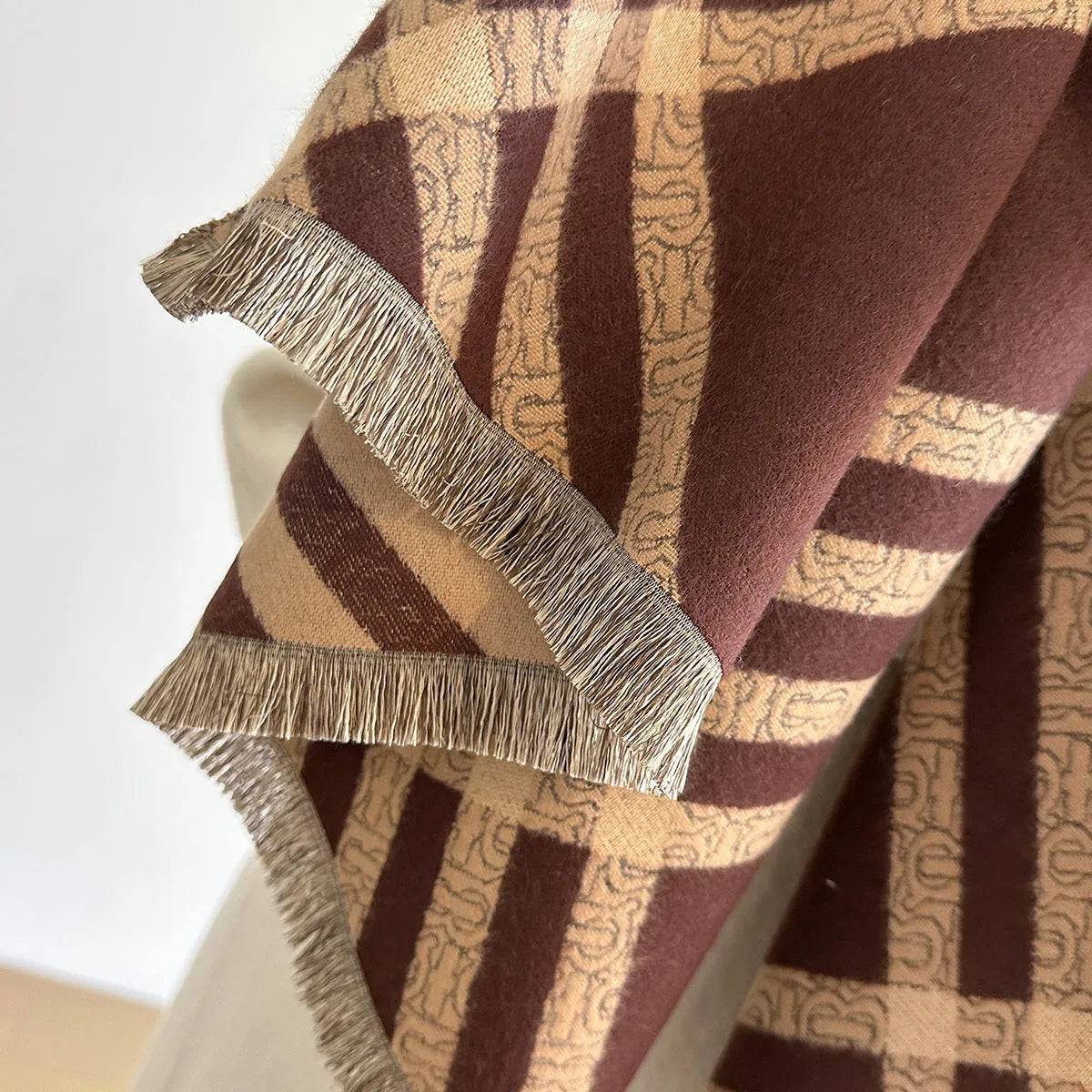 Long brown imitation cashmere scarf with tassels laid flat, showing its 185cm length.