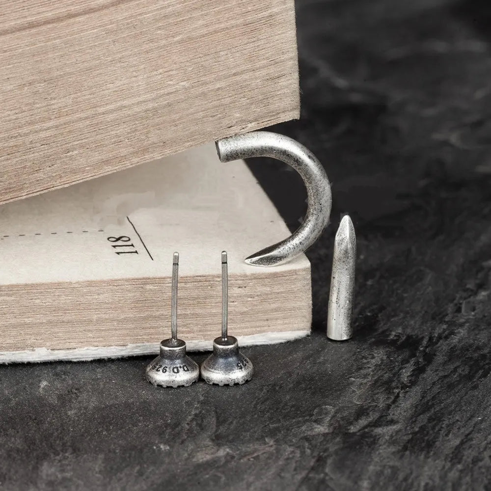 S925 sterling silver nail-shaped stud earring on an ear hook, punk style.