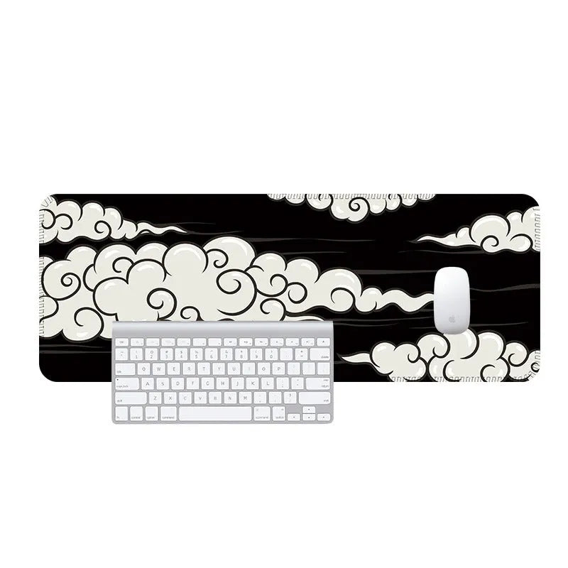 Large cloud pattern rubber desk mat with non-slip base on wooden desk surface