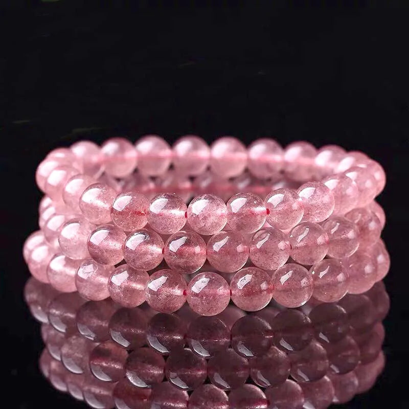 Women's strawberry quartz crystal bracelet with polished beads, showing size options of 6mm, 8mm, and 10mm.
