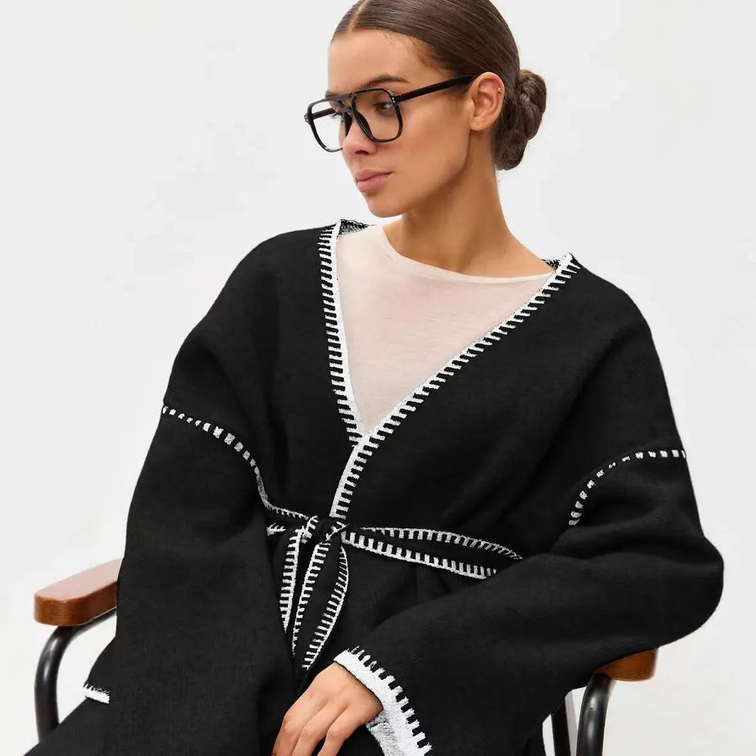 Loose fit knitted cardigan sweater coat in camel colour, showing long sleeves and mid-length hem.
