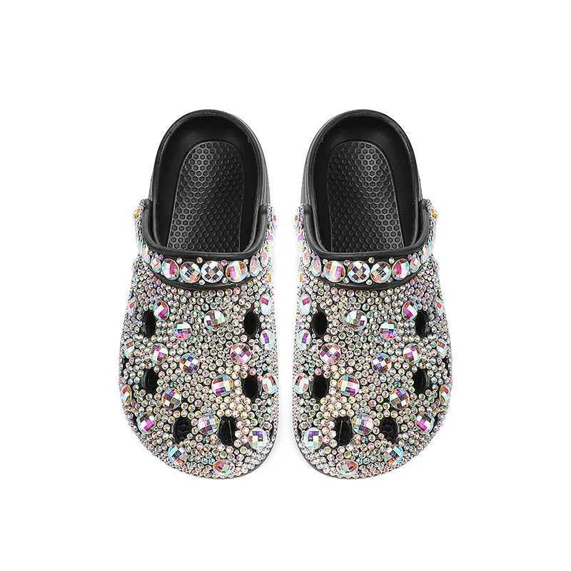 Black women's platform sandals covered in rhinestones with a chunky EVA sole.