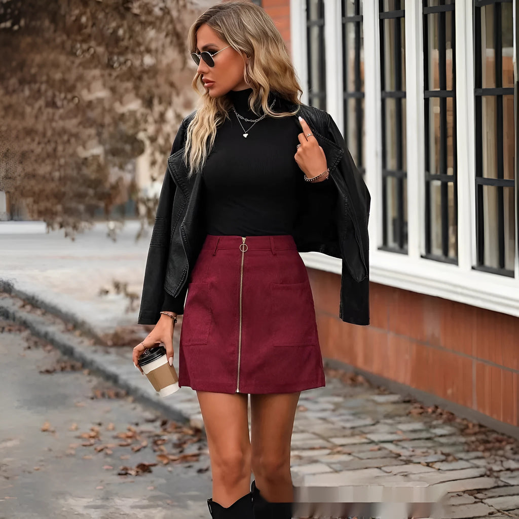 High-waist women's zip-front short skirt in polyester, shown in brick red colour with visible stitching detail.