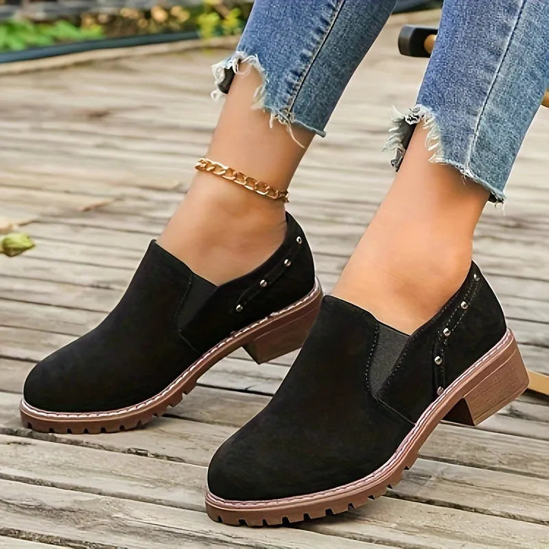 Women's light brown suede ankle boots with a thick low heel and elastic band fastening.