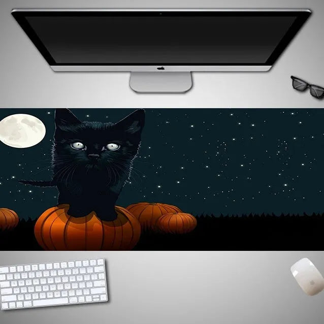 Oversized Halloween-themed computer mouse pad with non-slip rubber cloth base on a desk