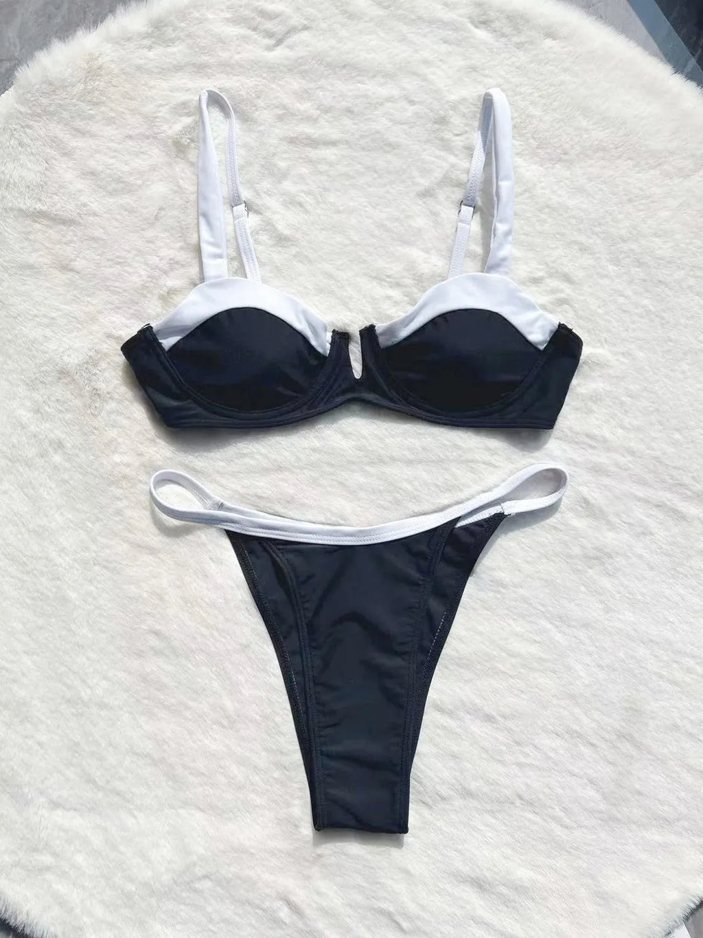 Black low waist women's bikini swimsuit with stitching split detail on briefs.