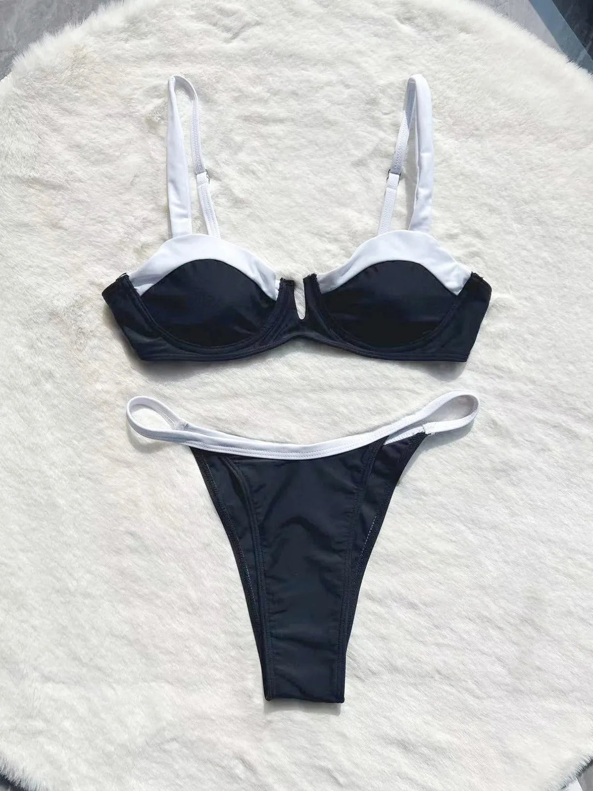 Black low waist women's bikini swimsuit with stitching split detail on briefs.