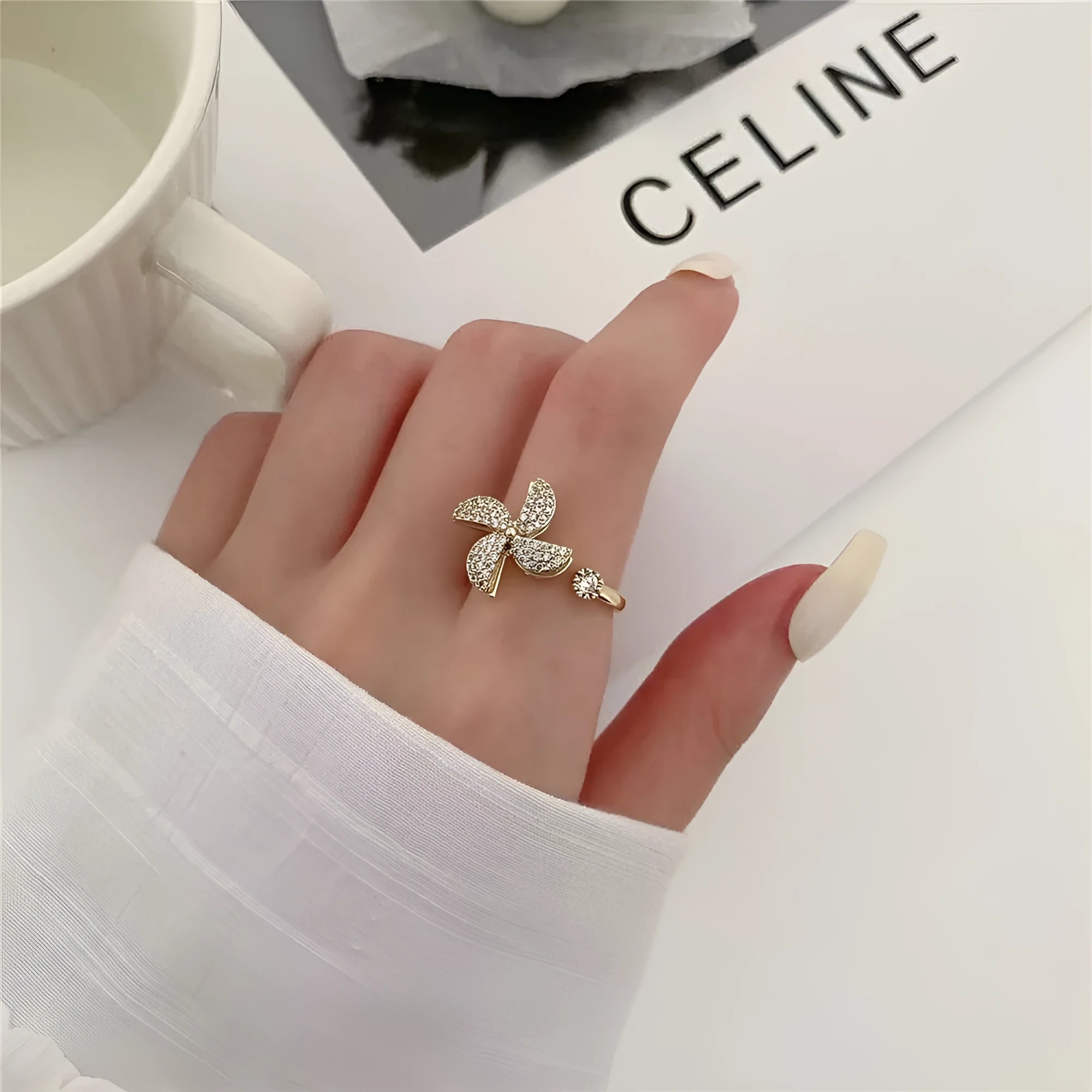 Rotating geometric ring with micro-inlaid windmill design in gold or silver electroplated finish