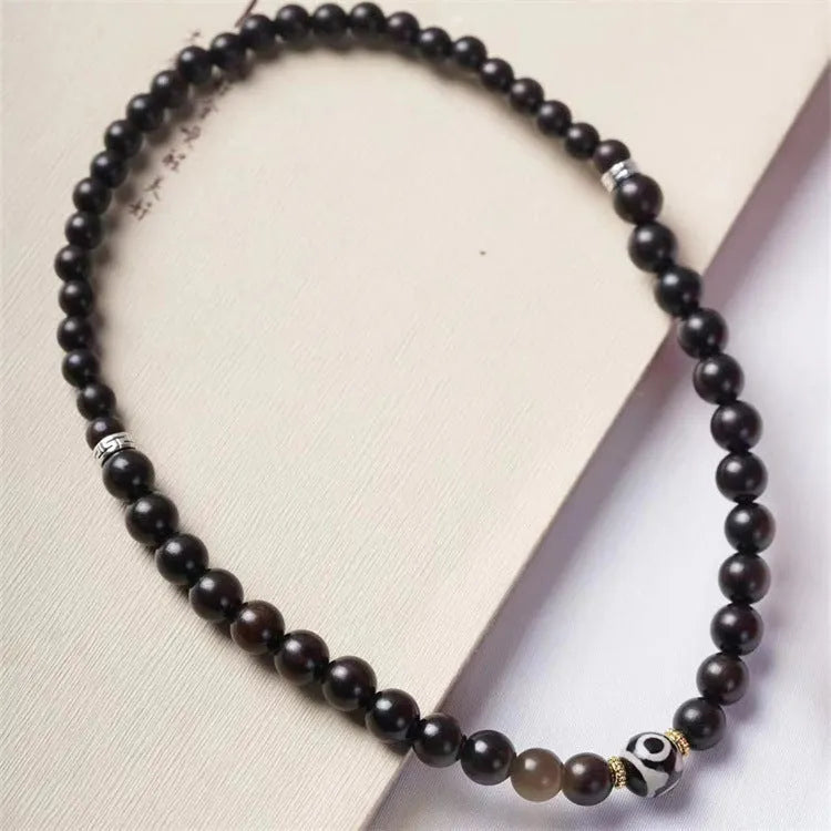 Ebony wood Tibetan bracelet with 8mm beads and two-circle pattern on wrist