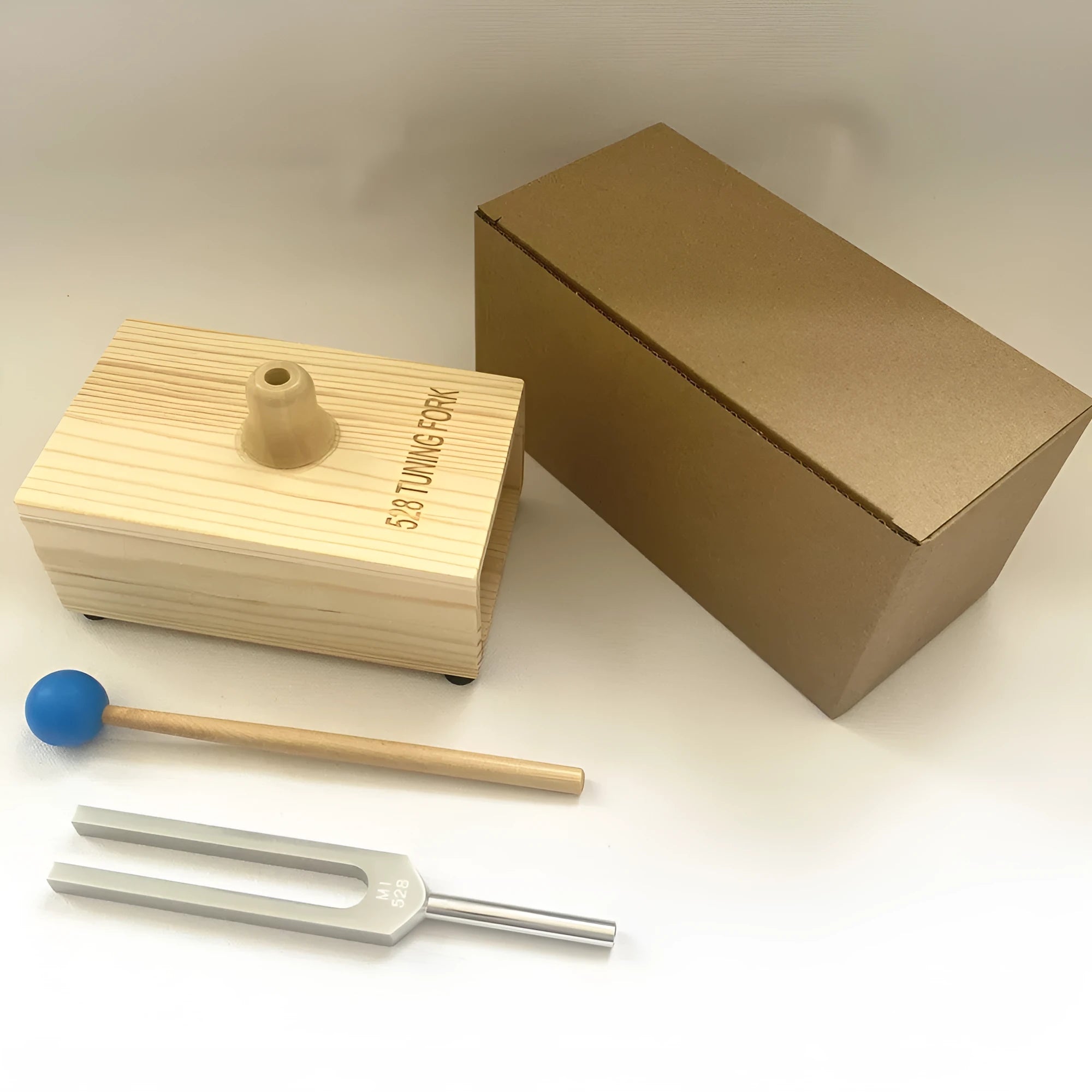 Aluminium alloy 432Hz tuning fork and portable speaker set in kraft paper box.